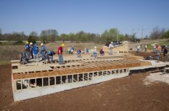 Habitat for Humanity volunteers begin work on one of two homes being built during the RV Care-A-Vanner 25th anniversary celebration in Springfield, Mo