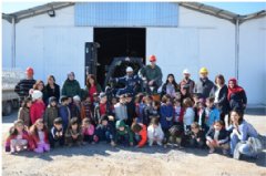 Safar Oilfield Services personnel take a photo with the children and staff from IDBEC during the facilities tour in Erbil.