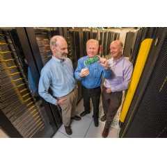 Sandia National Labs’ Roger Suppona, left, and John Naegle, center, and Lewis Rhodes Labs CEO David Follett examine their Neuromorphic Cyber Microscope. This small processor can replace racks of conventional cybersecurity systems. Photo Randy Montoya