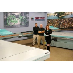 Mary Lou Goehrung, president, with her sons Glenn, far left, VP and COO, and Scott, VP and CTO, alongside their two Fujifilm Acuity F presses at the Rockville, Maryland facility.