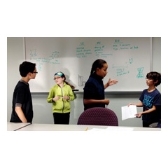 The software engineers of the 2015 Robotics Inventors Club resolving a coding issue in the plan to build an autonomous robot called A.N.A. (Autonomous Nurse Assistant) to assist nurses with patients who have Ebola.
