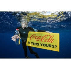A Greenpeace diver holds a banner reading “Coca-Cola is this yours?” and a Coke bottle found adrift in the Great Pacific Garbage Patch. Even hundreds of kilometres from any inhabited land, plastic can be found polluting our environment.