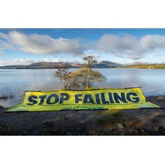 Greenpeace UK Kayakers with floating banner 