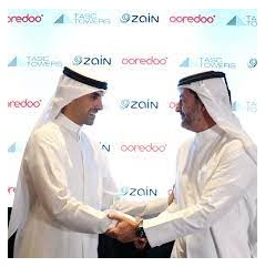 Bader Nasser Al-Kharafi and Aziz Aluthman Fakhroo sign the deal