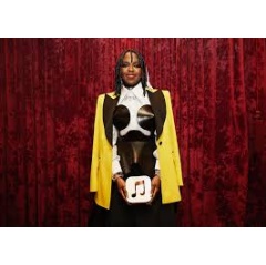 Lauryn Hill poses with her 100 Best Albums award, which is made of blasted anodized aluminum, sourced entirely from recycled Apple products. Photo by Irma Mchedlishvili.