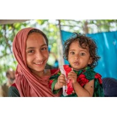 UNICEF/UNI403549/Karimi
A child named Zarmina receives RUTF at a UNICEF-supported mobile health and nutrition site in Samsagal village in Afghanistan.