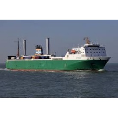 A cargo ship with modern wind propulsion using rotating vertical cylinders. Photo Credit: Shutterstock / Martin Lueke.