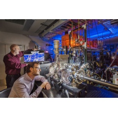 Sandia researchers Michael Chandross, left, and Nic Argibay show a computer simulation used to predict the unprecedented wear resistance of their platinum-gold alloy, and an environmental tribometer used to demonstrate it. Photo by Randy Montoya.