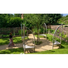 A visitor walking toward the seating area in the Garden Snug at Red House, London National Trust / Chris Davies