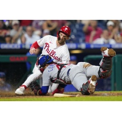 Philadelphia Phillies’ Bryce Harper, left, scores past Chicago Cubs catcher Willson Contreras during the sixth inning of a baseball game, in Philadelphia. (AP Photo/Matt Slocum)