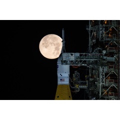 A full Moon is seen shining over NASA�s SLS (Space Launch System) and Orion spacecraft, atop the mobile launcher. 
NASA/Sam Lott