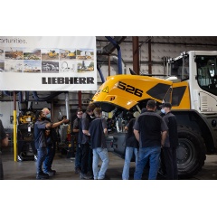 ATI students examining the wheel loader engine compartment