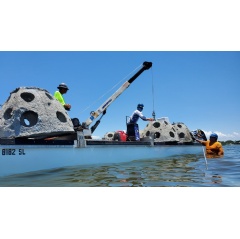 Florida Sea Grant-trained marine contractors work to install concrete domes that form the basis of an oyster reef. (Image credit: Larry Beggs, Reef Innovations Inc.)
