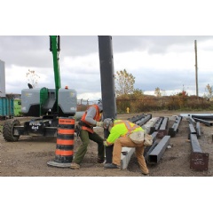Ironworkers install the first of 228 steel structural columns in the ongoing construction of the new cutting-edge Stellantis North America Battery Technology Centre located at the Automotive Research and Development Centre (ARDC) in Windsor, Ontario.