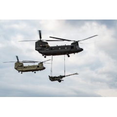 A U.S. Army CH-47F Block II Chinook conducts a sling load test alongside a CH-47F Block I aircraft. (Photo credit: Collin Magonigal U.S. Army Aviation Flight Test Directorate (AFTD))