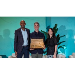 UEFA Executive Director of Social and Environmental Sustainability Michele Uva (centre) receives the Environmental Leadership Award from Roger McClendon and Aileen McManamon of the Green Sports Alliance.
