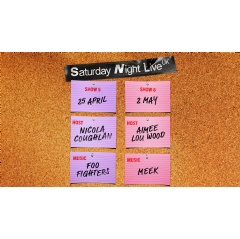 A corkboard display titled �Saturday Night Live UK� with pinned cards showing upcoming episodes. Show 5 is on 25 April, hosted by Nicola Coughlan with music by Foo Fighters. Show 6 is on 2 May, hosted by Aimee Lou Wood with music by Meek.